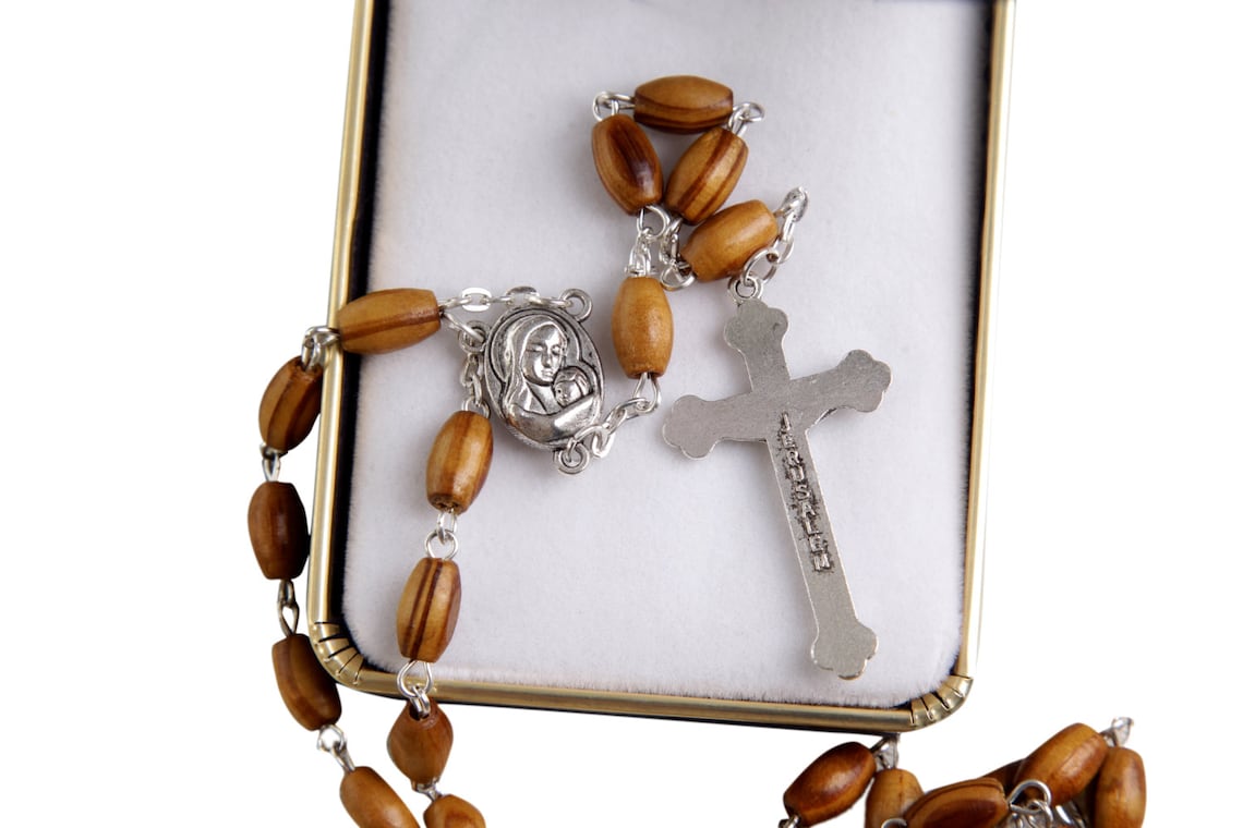 Holy Land Olive Wood Rosary with a Silver Cross and contains Holy Soil from the Holy Land where Jesus walked inside a premium velvet box.