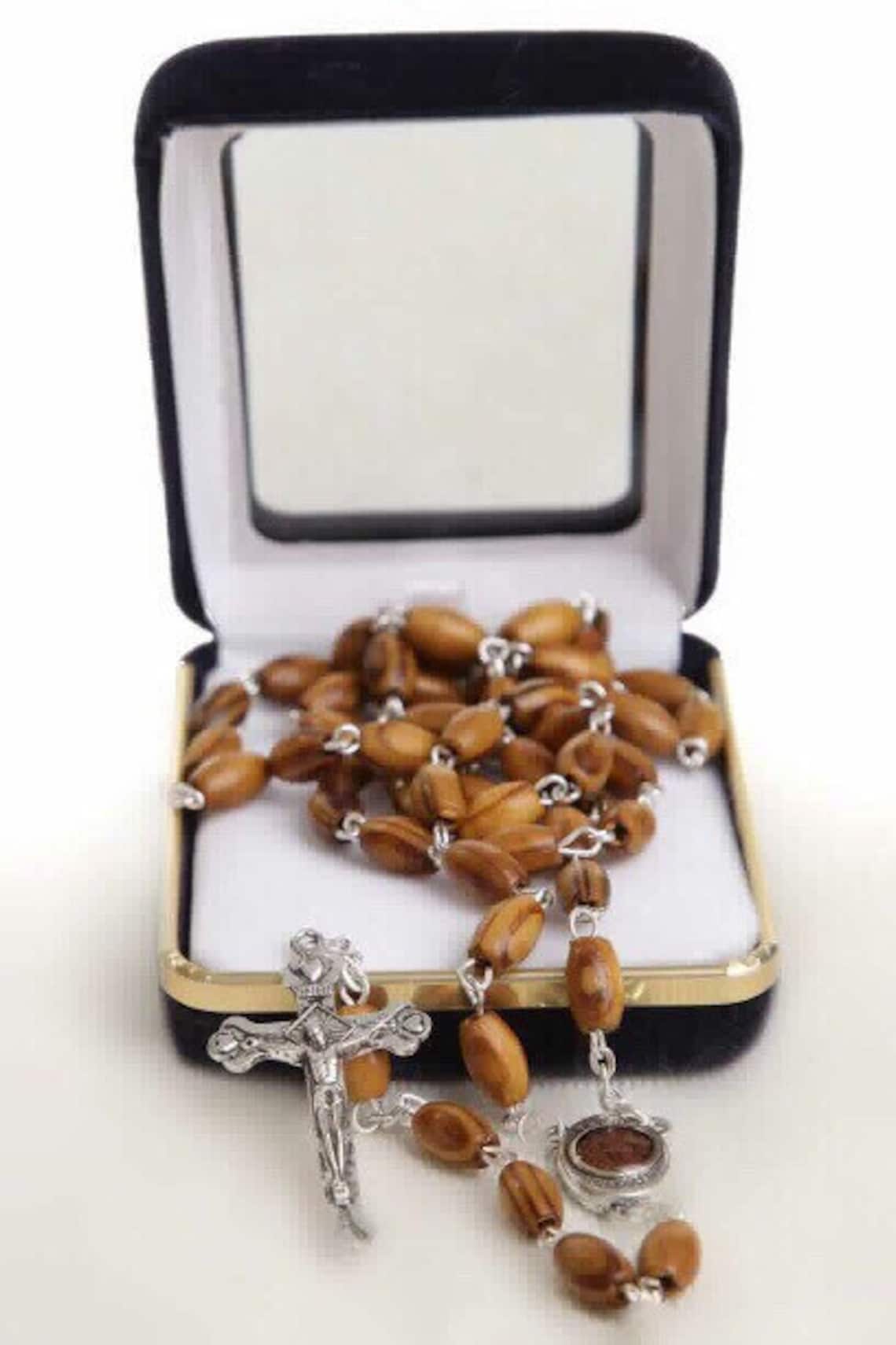 Holy Land Olive Wood Rosary with a Silver Cross and contains Holy Soil from the Holy Land where Jesus walked inside a premium velvet box.